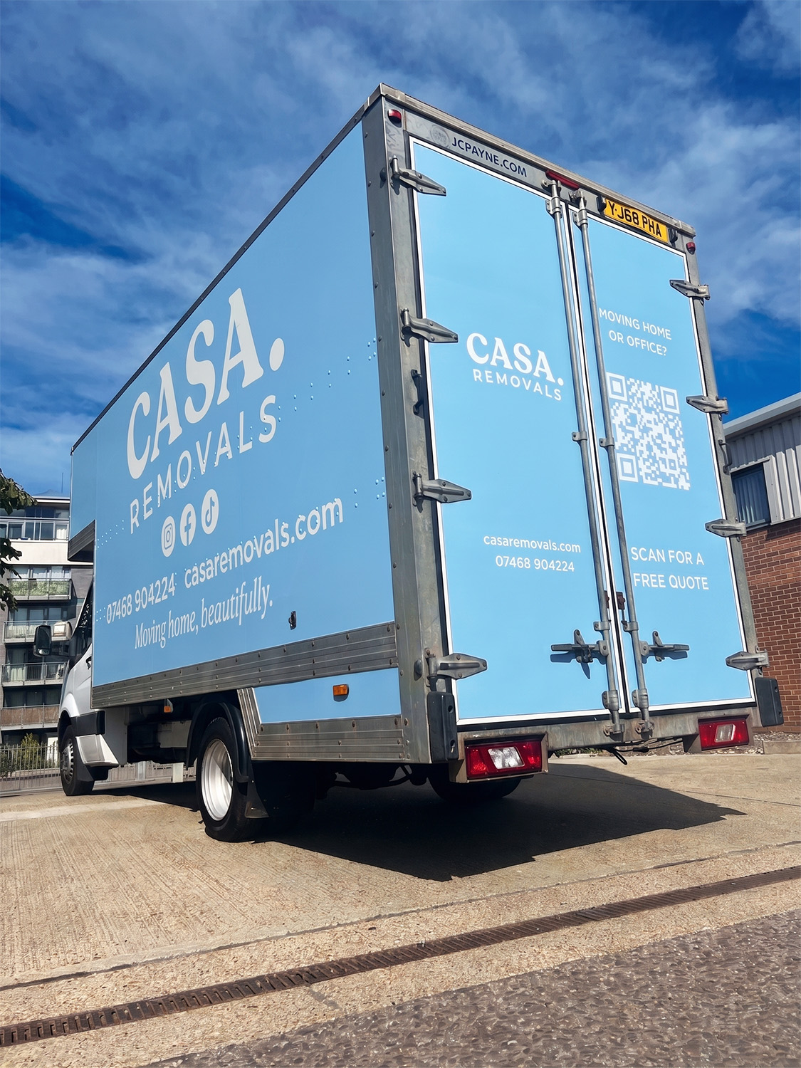 The rear of a CASA. van, with a QR code for a free quote